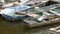 Many vintage old boats stand on the dock on river