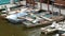 Many vintage old boats stand on the dock on river