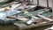 Many vintage old boats stand on the dock on river