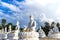 Many white buddha statues sitting in row on thai temple