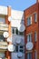 Many white parabolic satellite antenna dishes hanged on wall of suburban perfab block of flats
