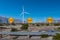 Many wind machines in the desert with 3 end signs