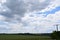 many wind power plants, power lines and grain fields below