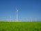 Many wind turbines standing on German field with lush green grass in spring, Nordfriesland, Germany, Europe