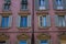 Many windows. Medieval facade. Window shutters. Architectural style of Italy