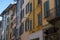 Many windows. Medieval facade. Window shutters. Architectural style of Italy