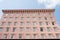 Many Windows in Pink Stucco Hotel