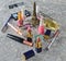 Many women& x27;s cosmetics for make-up and beauty care on a gray concrete background. Nail polish, perfume bottle, makeup shadows