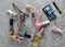 Many women& x27;s cosmetics for make-up and beauty care on a gray concrete background. Nail polish, perfume bottle, makeup shadows