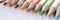 Many wooden sharp multicolored pencils lying on white background