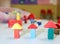 Many wooden toys and pieces of buildings in the nursery class