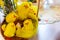 Many yellow Easter chicks in wicker Easter basket decorated with green boxwood branches