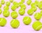 Many yellow tennis balls on a light floor with focus in the foreground. 3D rendering