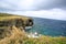 Manzamou with gloomy sky. A coral reef cliff against which raging waves crash, landmark in okinawa