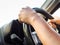 Manâ€™s hands holding steering wheel and road background. Drivin