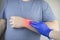 A manâ€™s wrist hurts. Traumatologist examines a hand. Wrist pain as a sign of tunnel syndrome or sprain, tendon degeneration,