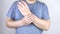 A manâ€™s wrist hurts. Traumatologist examines a hand. Wrist pain as a sign of tunnel syndrome or sprain, tendon degeneration, art