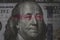 Mao Tse Tung eye from Yuan banknote insert on Benjamin Franklin face on USD dollar banknote for symbol of economic tariffs trade