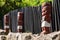 Maori wood carving, New Zealand. Row of warrior figures against a fence