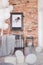 Map in black frame on brick wall in fashionable bedroom interior with industrial single bed with grey bedding and bunch of white
