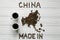 Map of the China made of roasted coffee beans laying on white wooden textured background cups of coffee