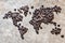 Map of continents from coffee beans on a wooden background