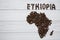 Map of the Ethiopia made of roasted coffee beans laying on white wooden textured background