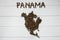 Map of the Panama made of roasted coffee beans laying on white wooden textured background