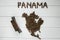 Map of the Panama made of roasted coffee beans laying on white wooden textured background with toy train