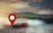 Map pointer icon placed on cliff, background is view and tropical landscape and lake,With concept of using technology to help