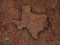 Map of Texas on rusty metal