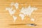 Map of the world made of white rice with two bamboo sticks