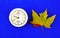 Maple leaf and vintage alarm clock blue background