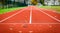 Maple leafs on athletic running track in stadium.