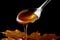 Maple Syrup Pouring onto a Spoon. AI