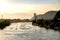 Marapendi Lagoon seen from above with houses on the hill during sunset, golden light. Jet skis are riding on the lake. Barra da Ti