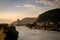 Marapendi Lagoon seen from above with houses on the hill during sunset, golden light. Jet skis are riding on the lake. Barra da Ti