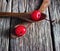 Maraschino cherry vibrant on wooden spoon and old table background