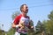 Marathon participant holds a bear toy during 31st international Belgrade race run on city street