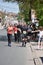 Marathon runners in red and black T-shirts run down Belgrade Street on a beautiful sunny day