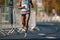 Marathon running race, African woman feet on autumn road. African runner running urban marathon in the the city