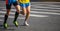 Marathon running race, two men runners on city roads, detail on legs