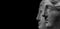 Marble ancient different heads as humankind in a isolated black background, streamer, banner with paste space