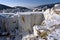 Marble blocks in abandoned Buguldeyka quarry in winter sunny day, Russia