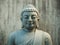 Marble Buddha face on grey background