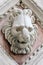 Marble detail of carved head of lion on church in Siena