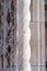 Marble details on facade of Messina Cathedral or Duomo di Messina, Sicily, Italy. Carved stone columns and reliefs, pink