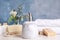 Marble dispenser, soap bars and luffa sponge on white wooden table