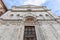 The marble facade with the terra-cotta relief in the tympanum above the wooden door of Renaissance Sant Agostino church