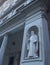 Marble figure of the saint in a niche wall. Florence city, Christmas in Italy.